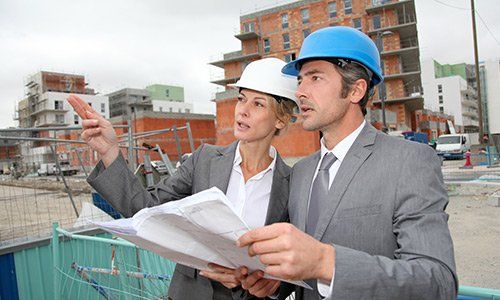 Construction engineers checking plan Construction engineers checking plan