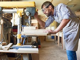 Skilled Carpenter Working on Cabinets — Beaumont, CA — Absolute Cabinets Inc Skilled Carpenter Working on Cabinets — Beaumont, CA — Absolute Cabinets Inc