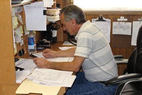 Charter Bus Services — Man Doing Paper Works in San Diego, CA Charter Bus Services — Man Doing Paper Works in San Diego, CA
