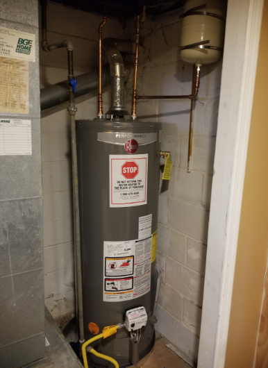 A water heater with a stop sign on it