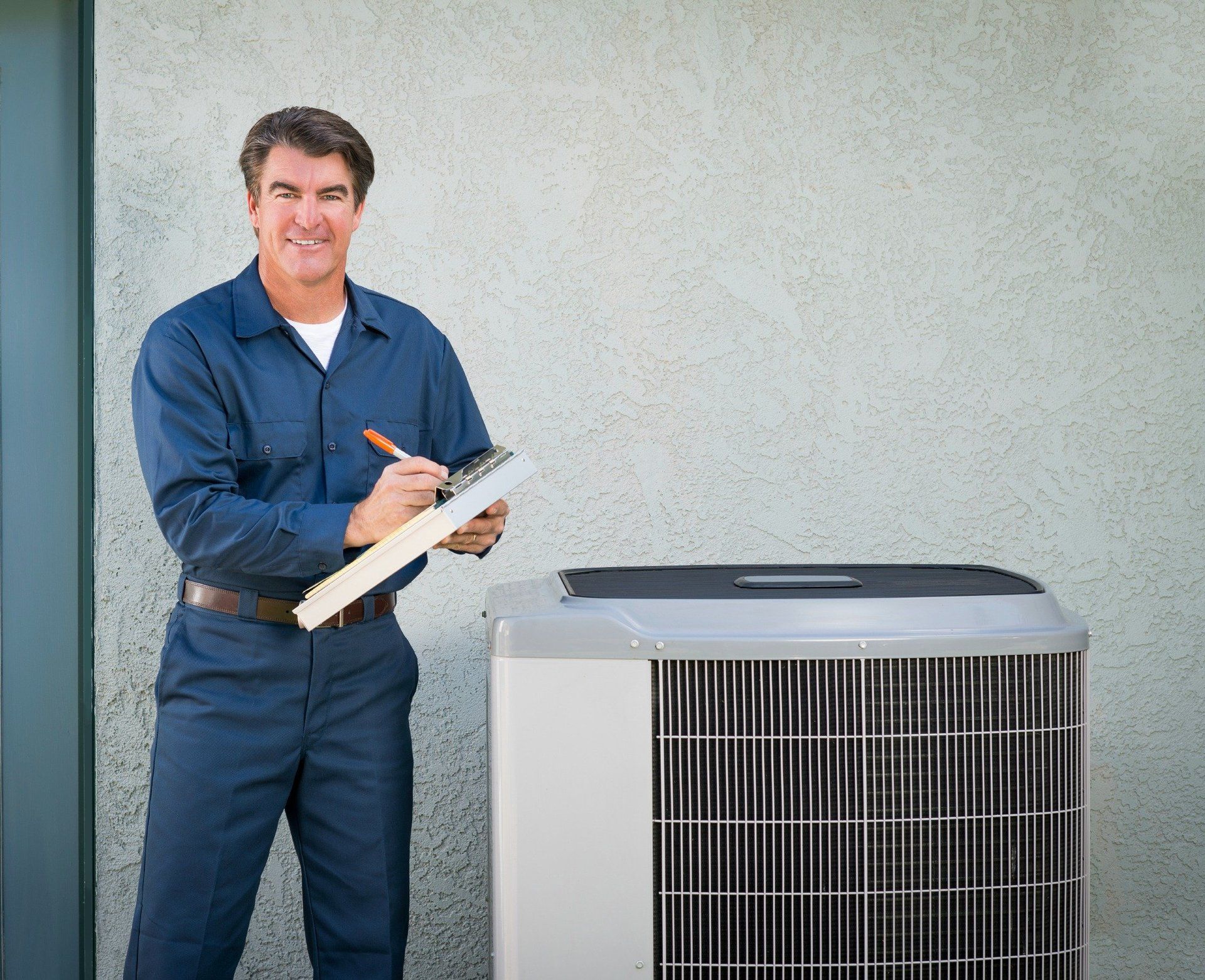 hvac service technician holding maintenance contract next to ac unit