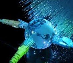 A globe is sitting on top of a glass with a bunch of wires coming out of it.