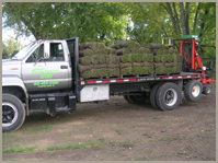 Truck loaded with grass — Gardening Supply in Crystal Lake, IL Truck loaded with grass — Gardening Supply in Crystal Lake, IL