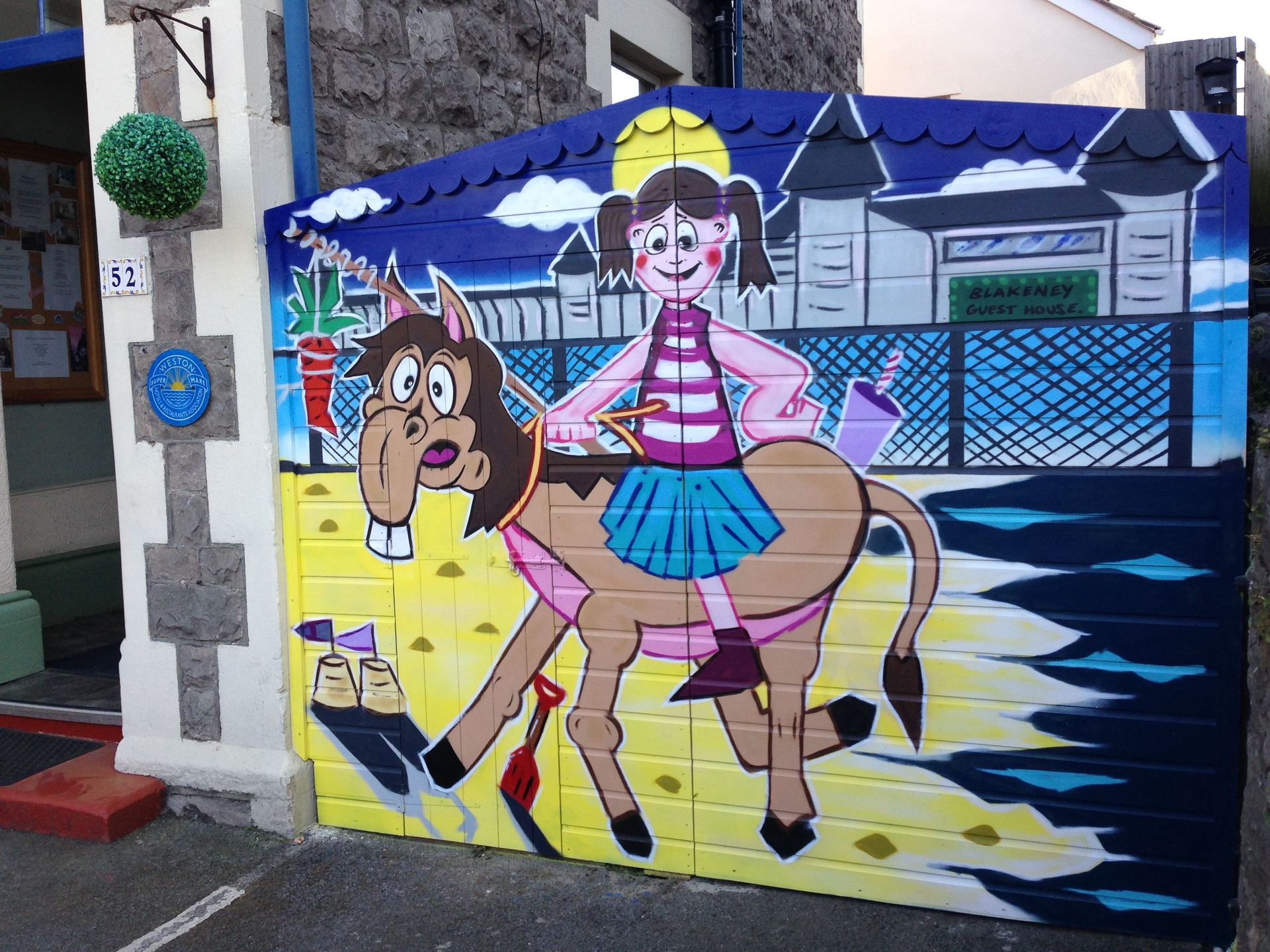Graffiti mural on a garage door at a B&B in WSM