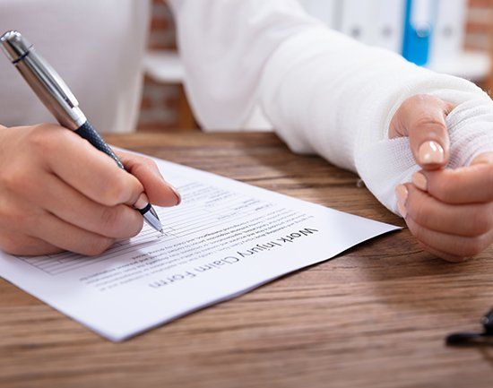 Injured Woman Filling Injury Form — Columbus, GA — The Law Office of Paul Bennett Injured Woman Filling Injury Form — Columbus, GA — The Law Office of Paul Bennett