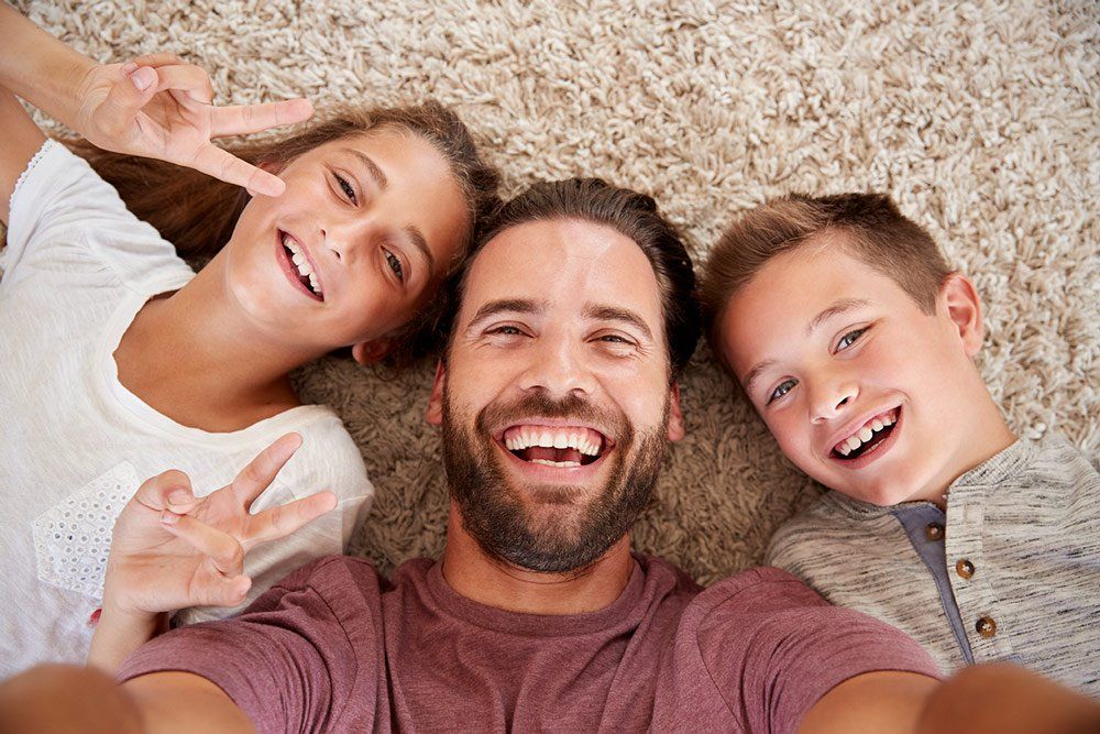 smiling father daughter son