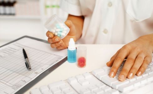 pharmacist processing medicine