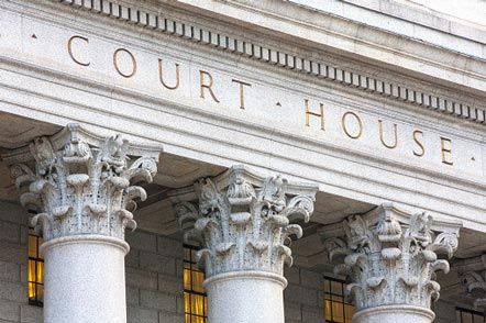 Man in Handcuffs in Courtroom — Law Firm in Portland, OR Man in Handcuffs in Courtroom — Law Firm in Portland, OR