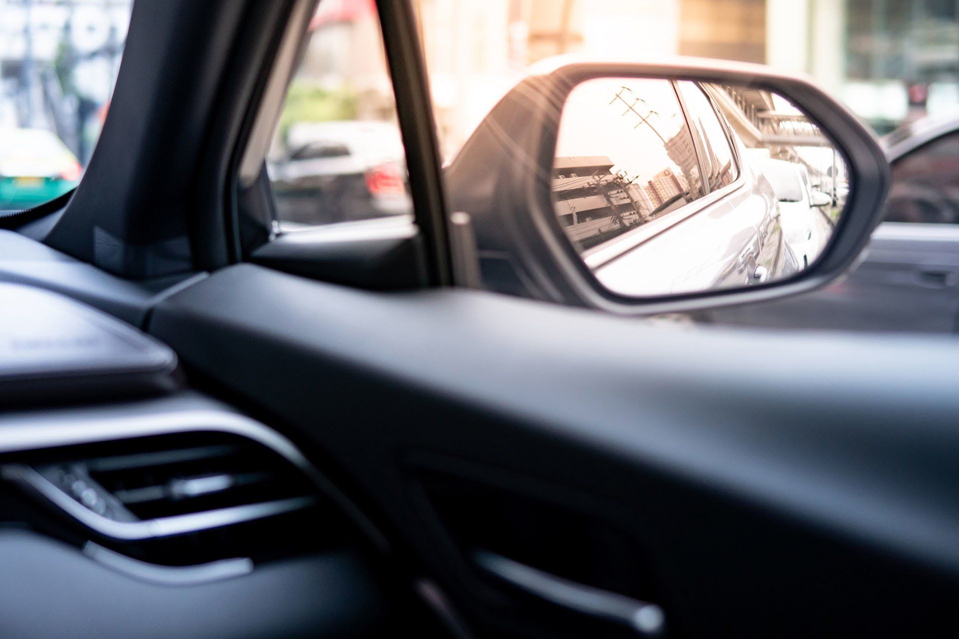 Reflection of Modern Car in Wing Mirror — Butler, PA — The West Agency, Inc. Reflection of Modern Car in Wing Mirror — Butler, PA — The West Agency, Inc.