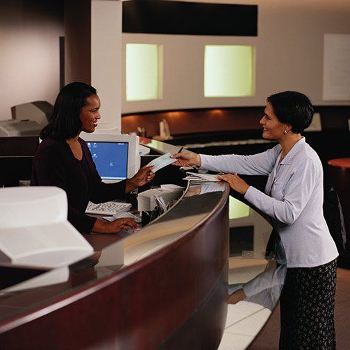 two people holding paycheck