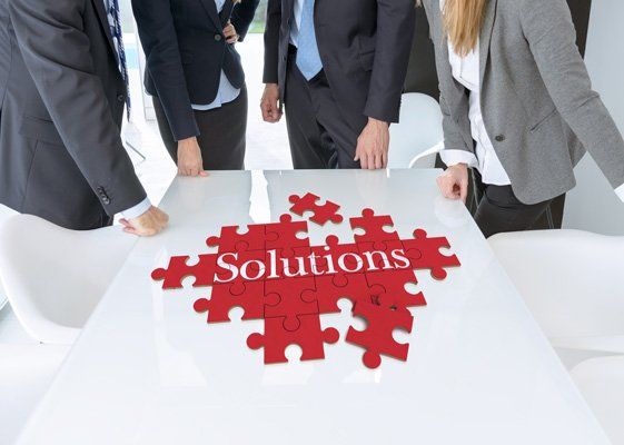 team working on a solutions puzzle