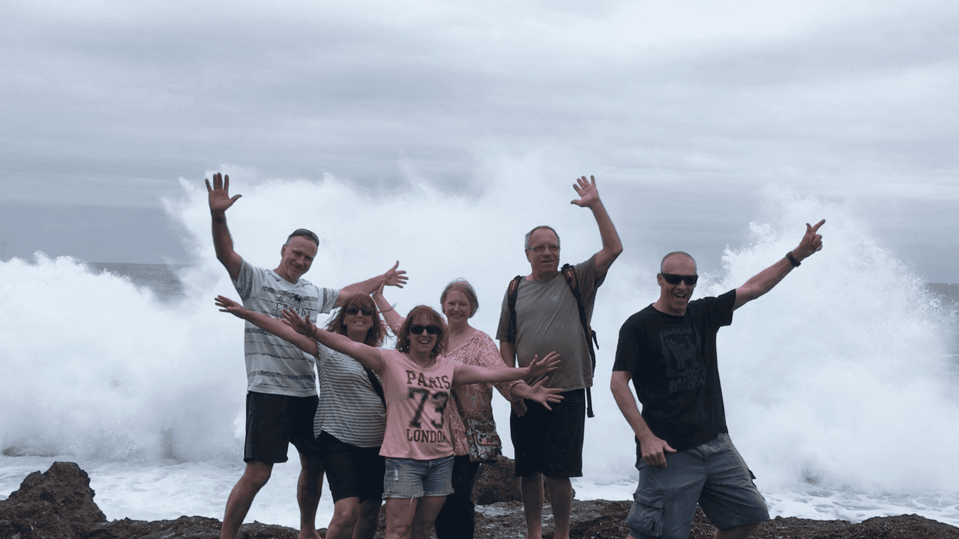 Group photo in front of pounding waves