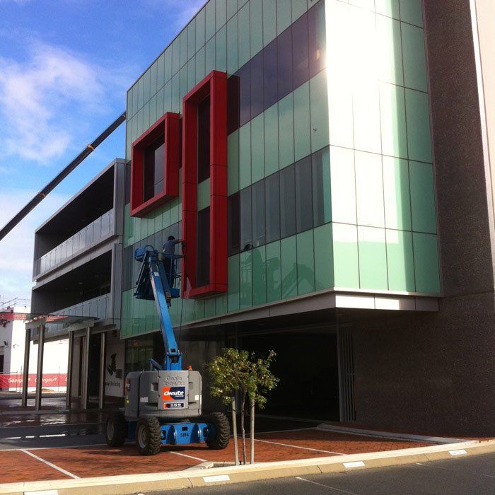 man washing university windows