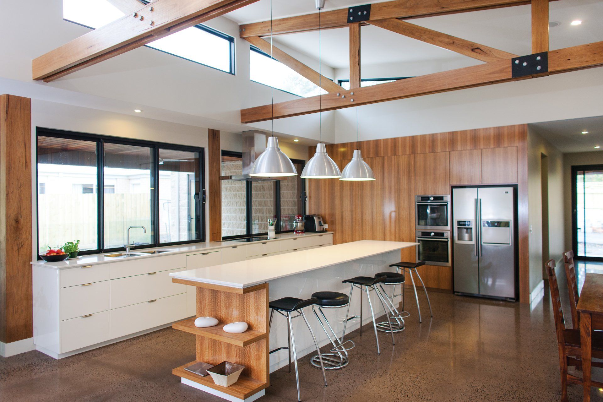 A kitchen with a large island and stools