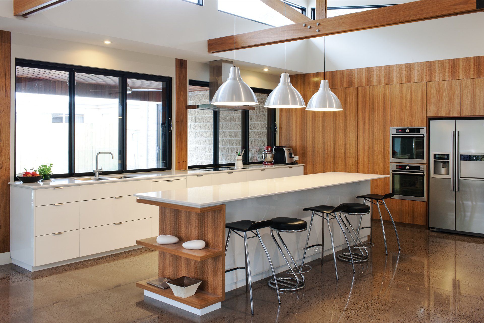 A kitchen with a large island and stools
