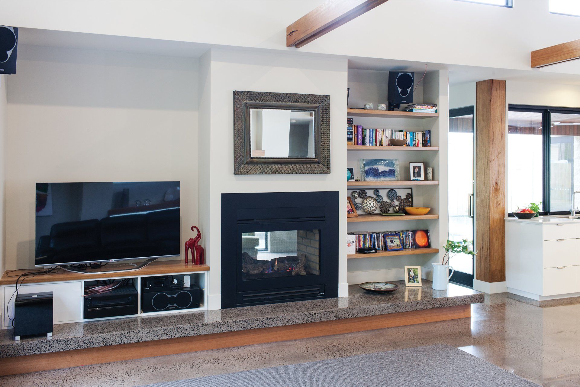 A living room with a fireplace and a flat screen tv