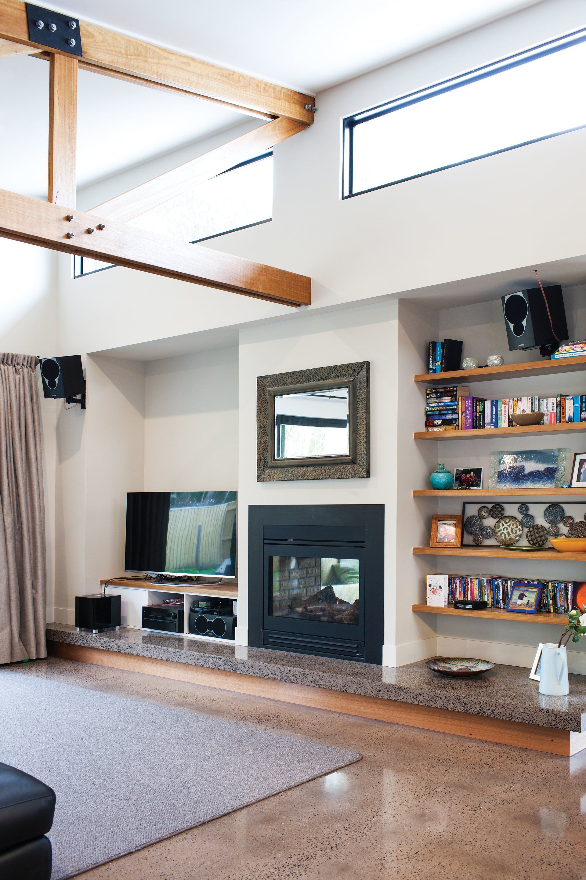 A living room with a fireplace and a television