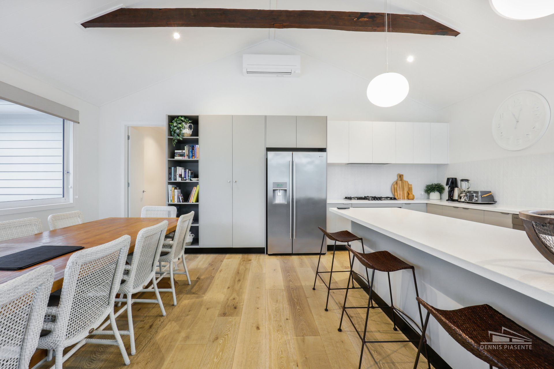 A kitchen with a table and chairs and a refrigerator.