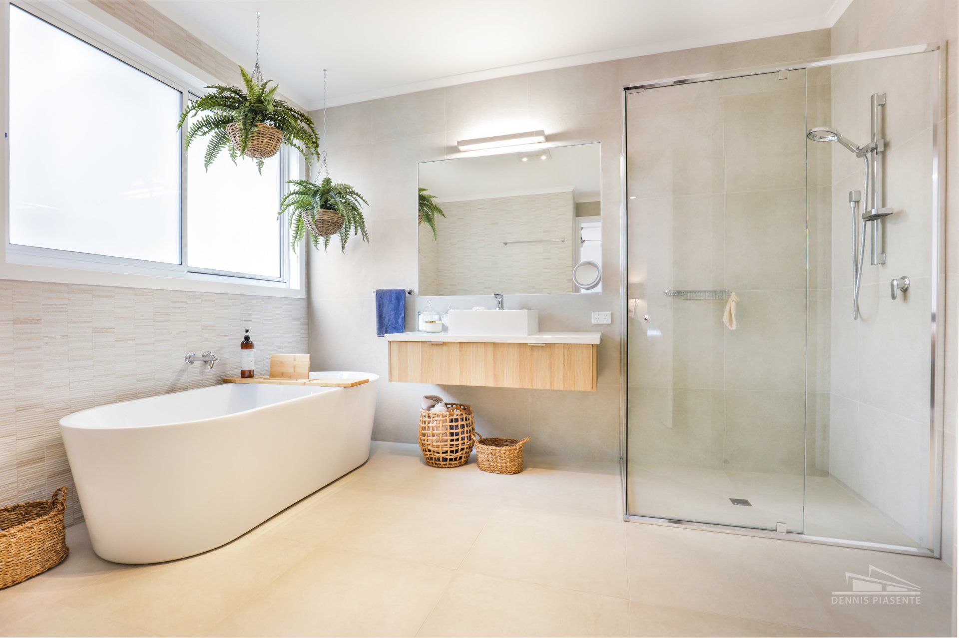 A bathroom with a bathtub , sink , mirror and walk in shower.