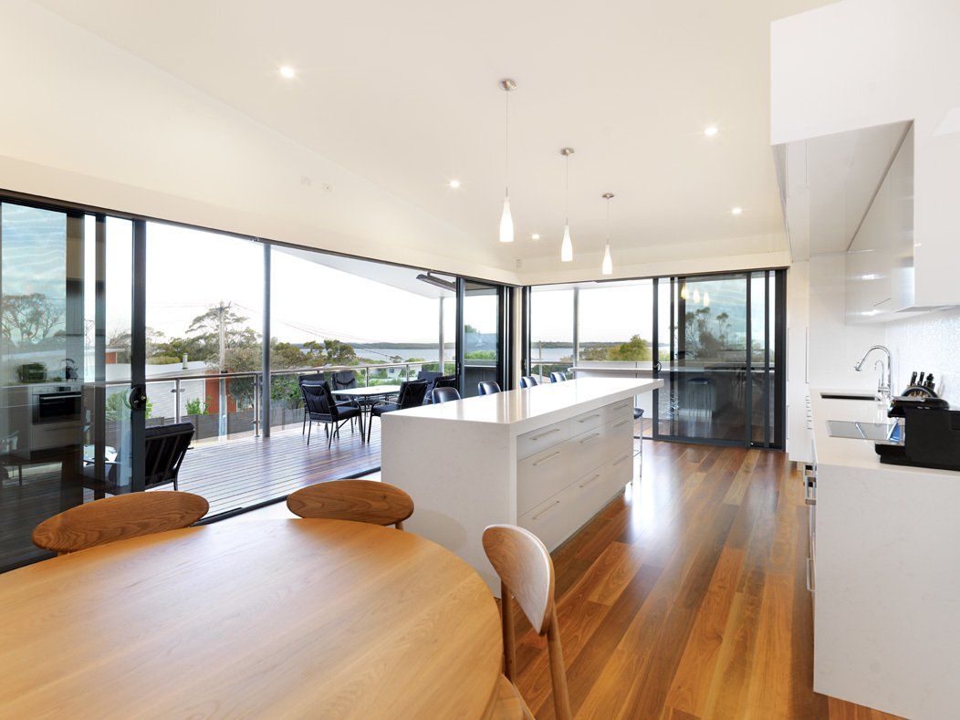 A kitchen with a table and chairs and a large island