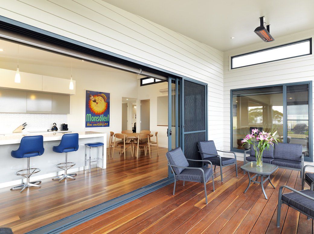 A large sliding glass door opens to a patio in a house.