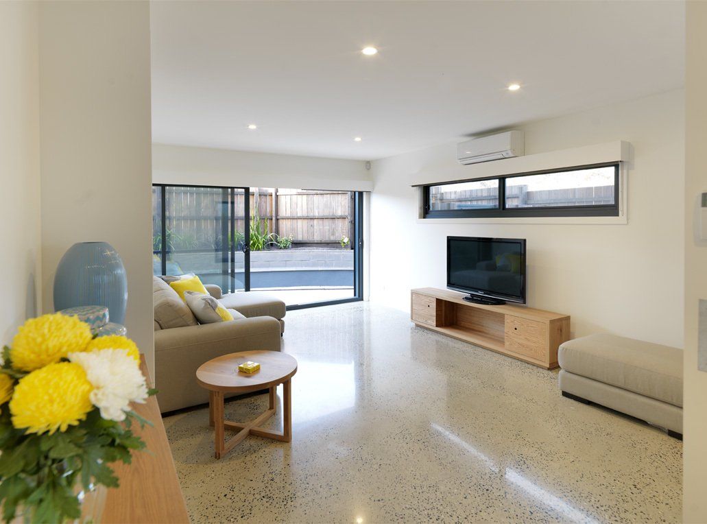 A living room with a couch a table and a television
