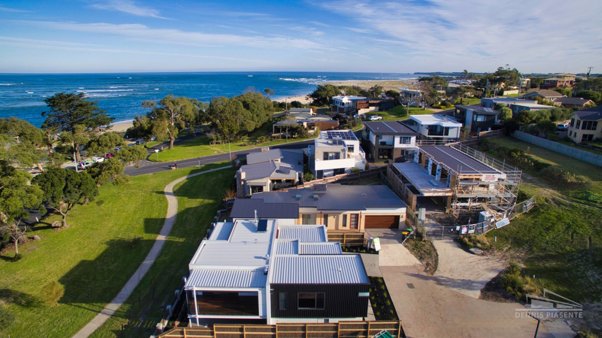 An aerial view of a residential area next to the ocean.