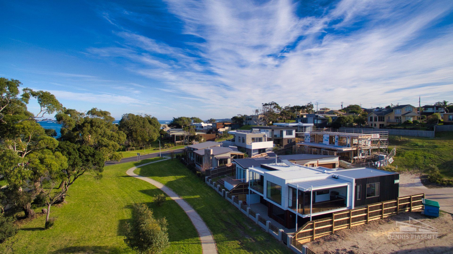 An aerial view of a house under construction in a residential area.
