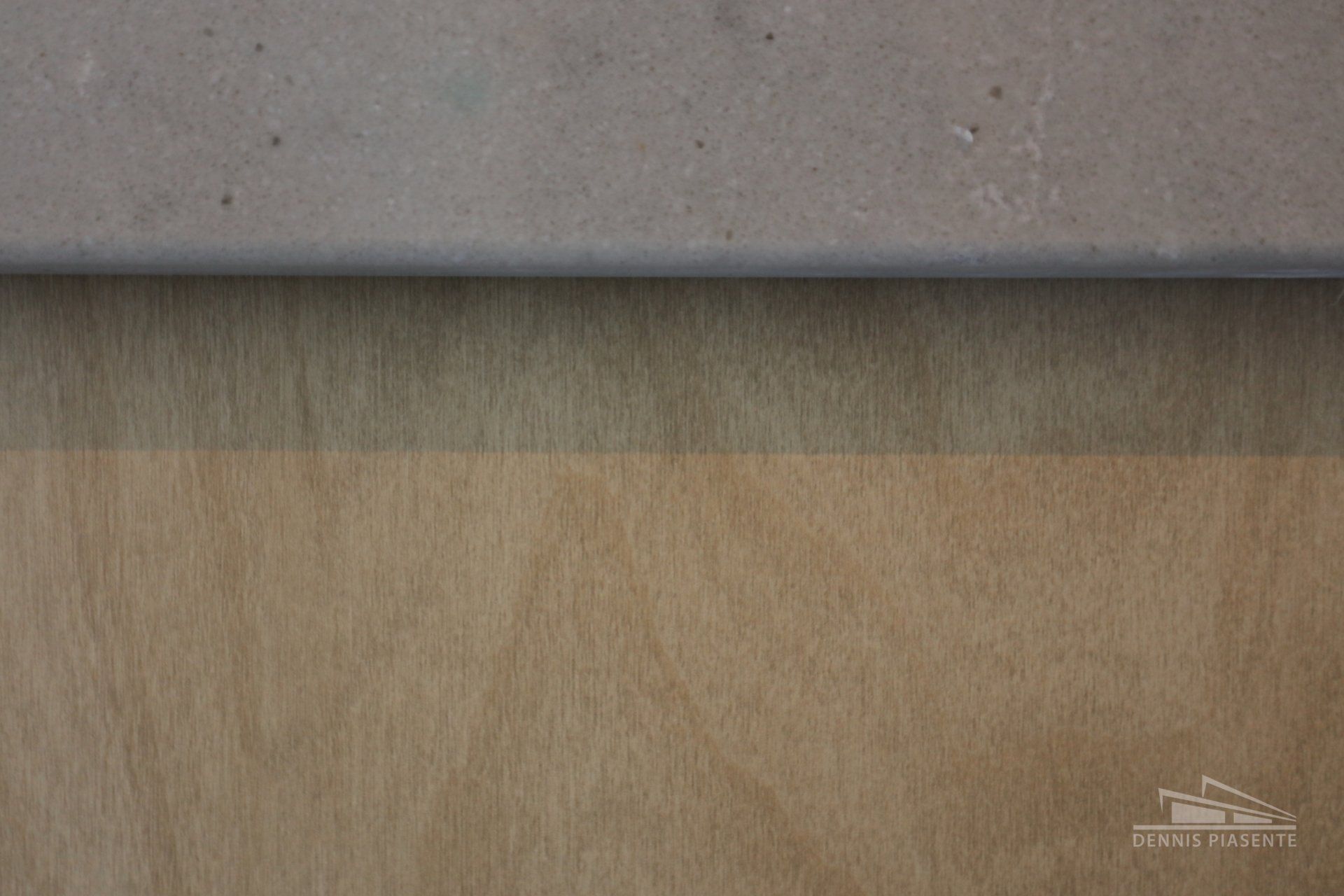 A close up of a piece of wood and a piece of paper.