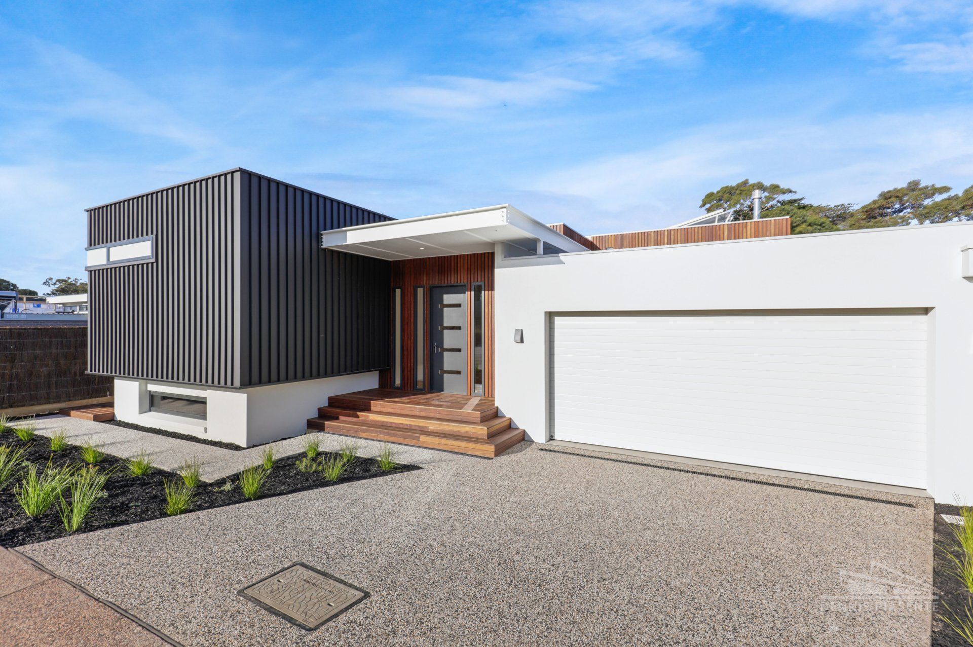 A modern house with a garage and a driveway.
