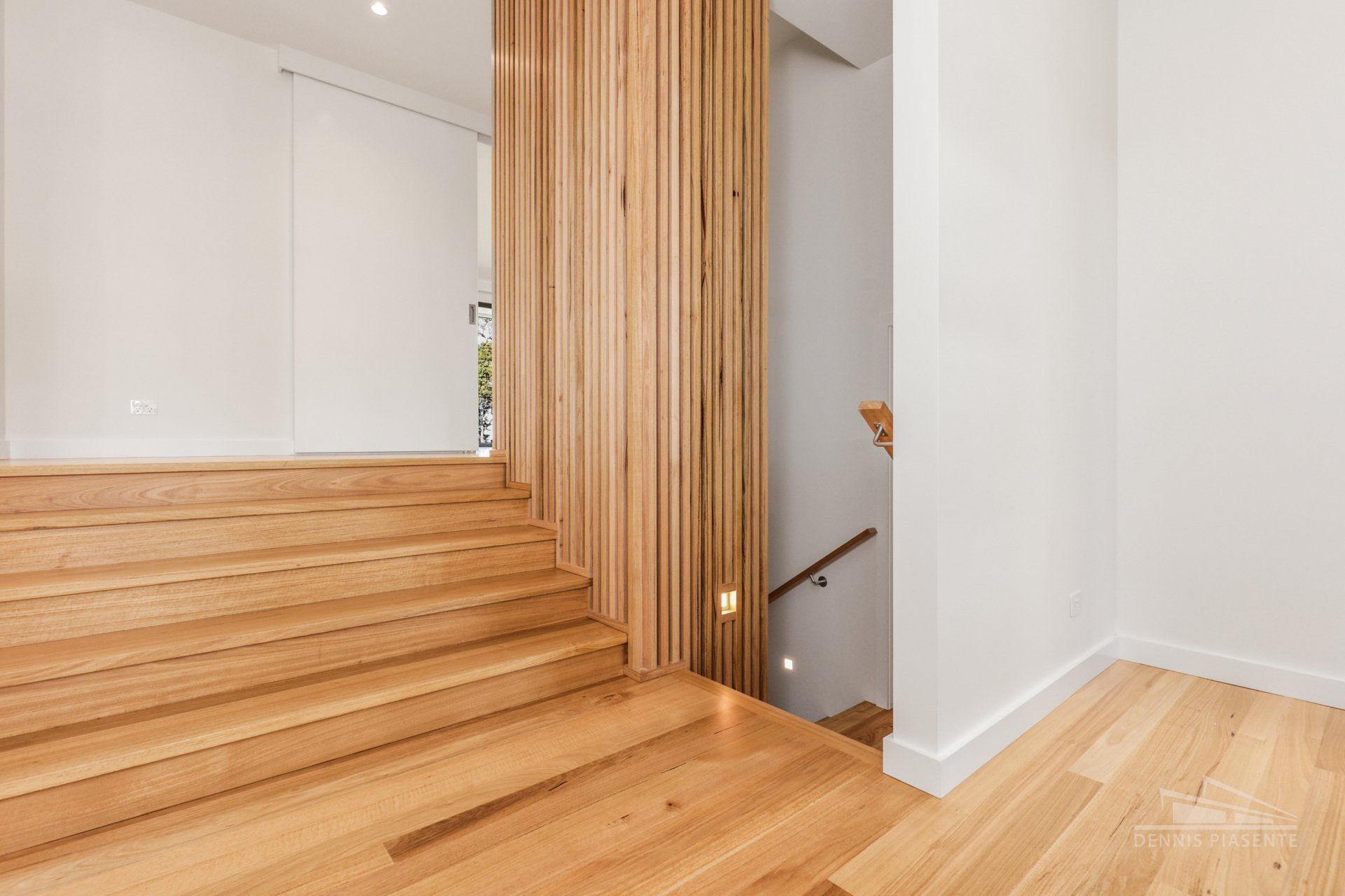 A wooden staircase leading up to the second floor of a house.
