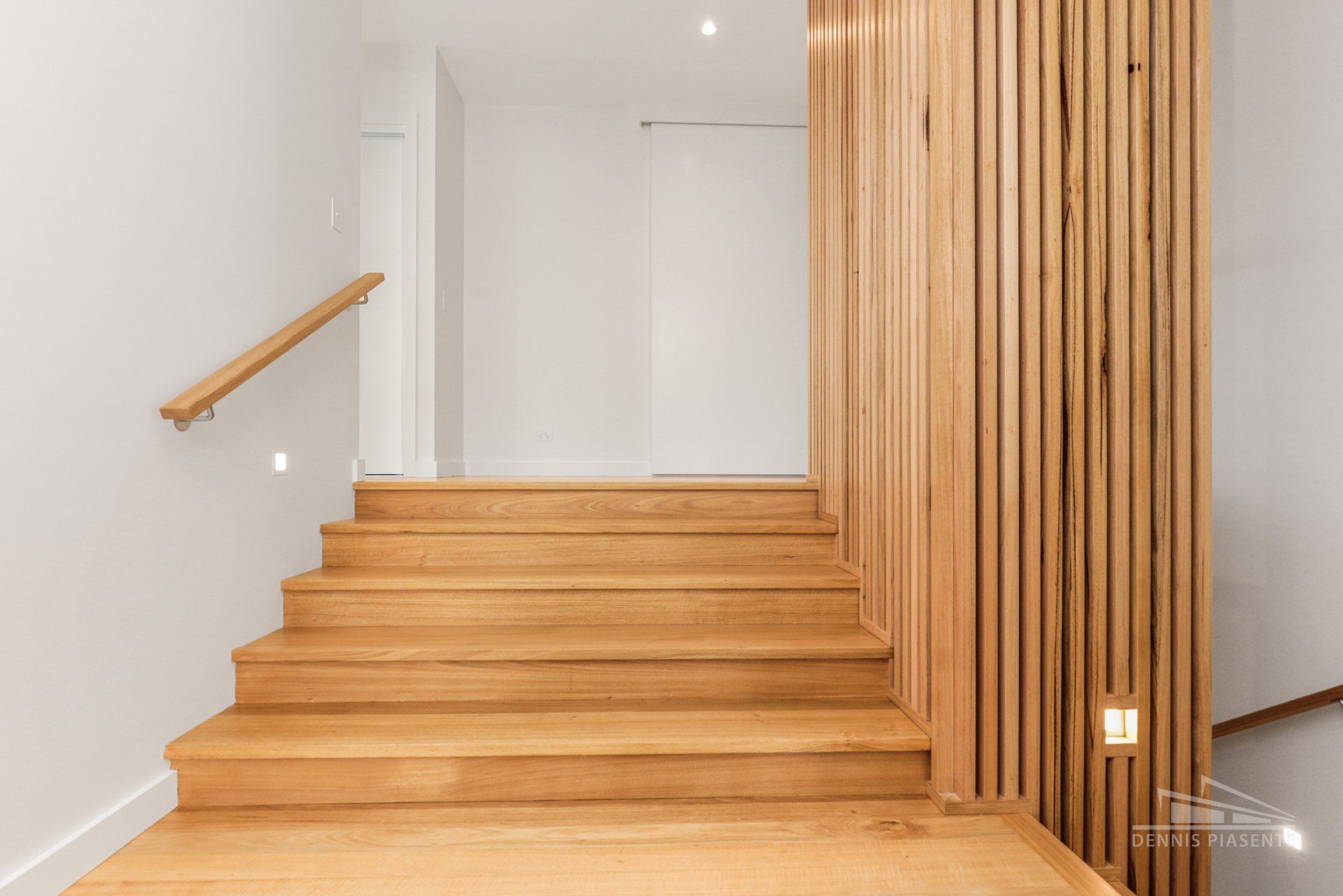 The stairs are made of wood and have a wooden railing.