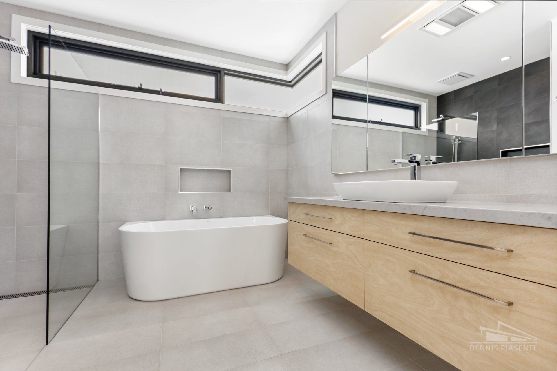 A bathroom with a bathtub , sink , mirror and walk in shower.