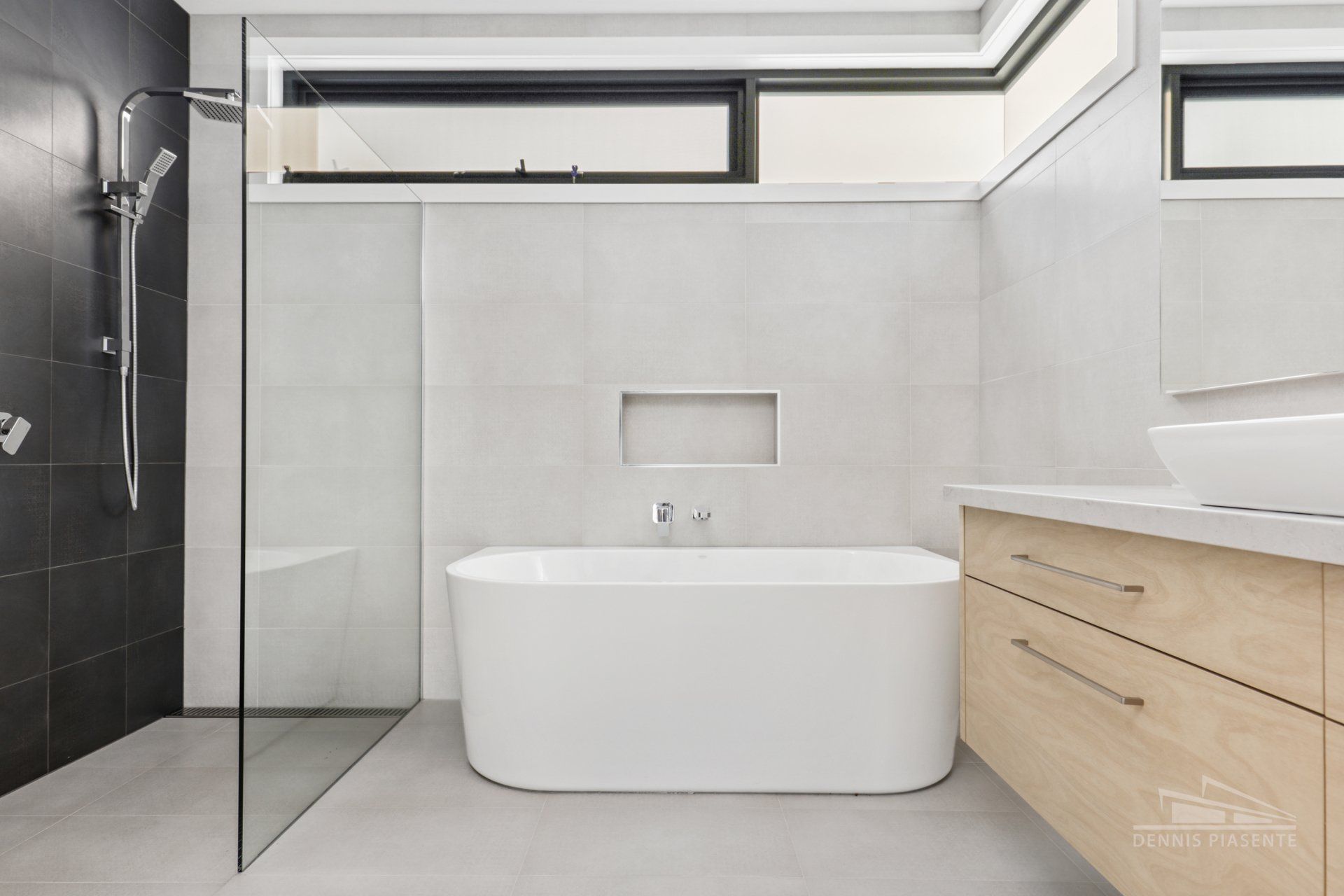 A bathroom with a bathtub , sink , and shower.