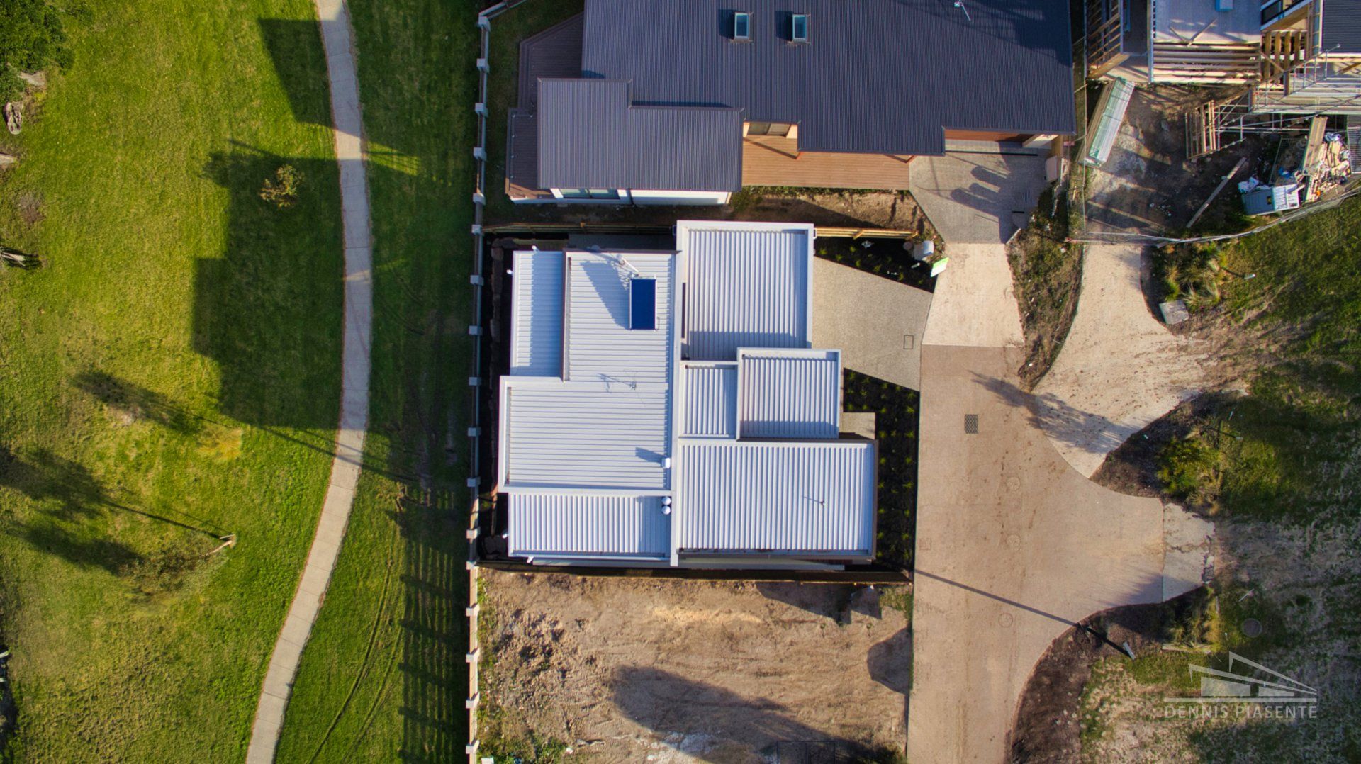 An aerial view of a house under construction in a residential area.