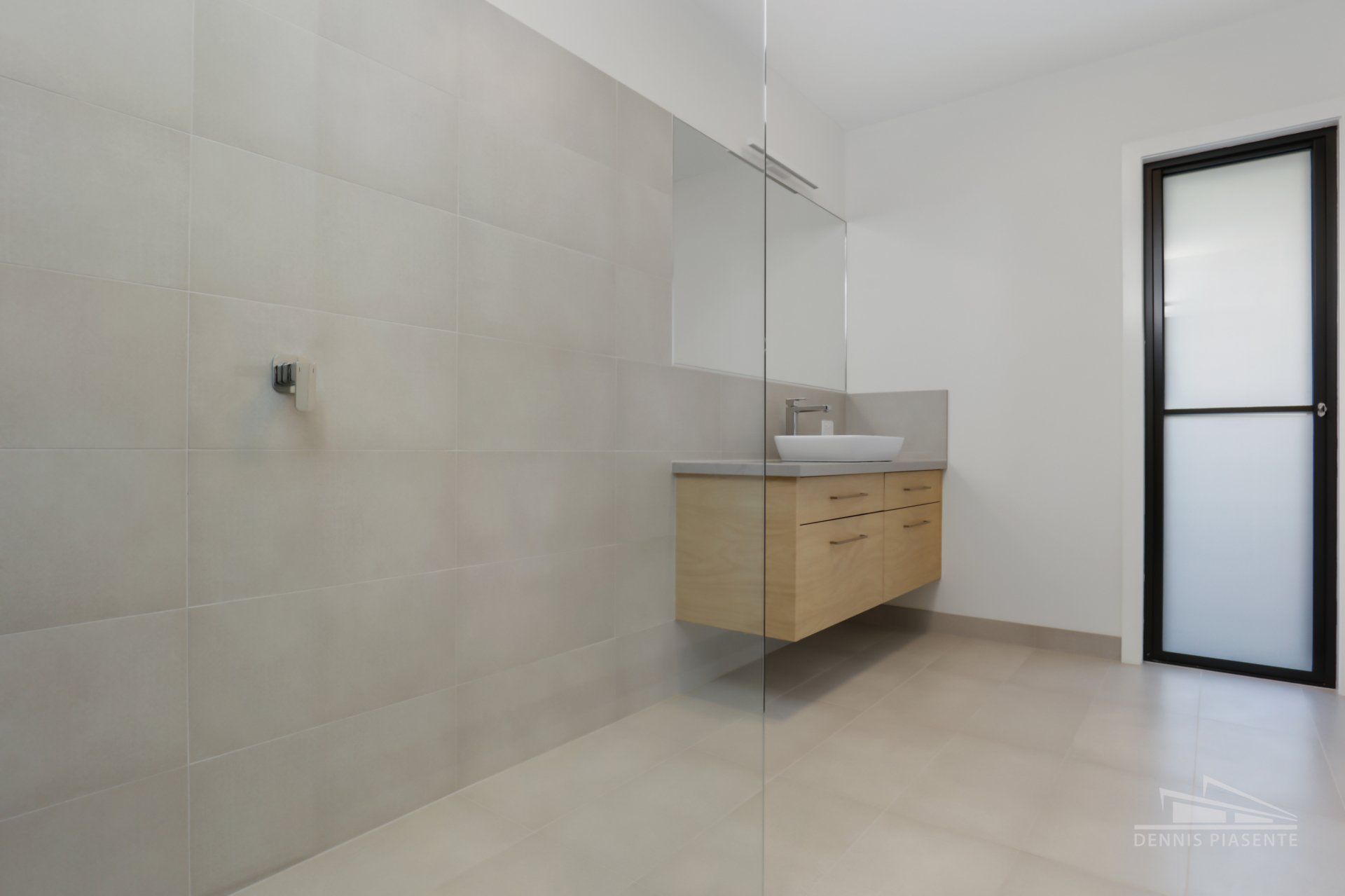 A bathroom with a sink and a walk in shower.