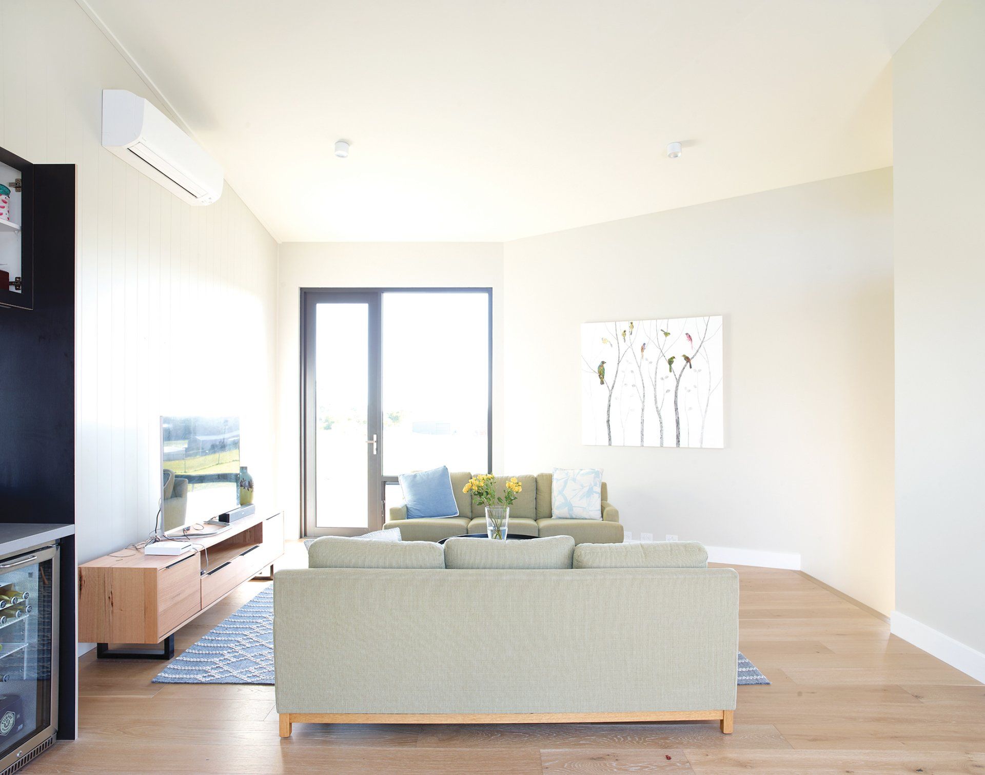 A living room with a couch and a television.