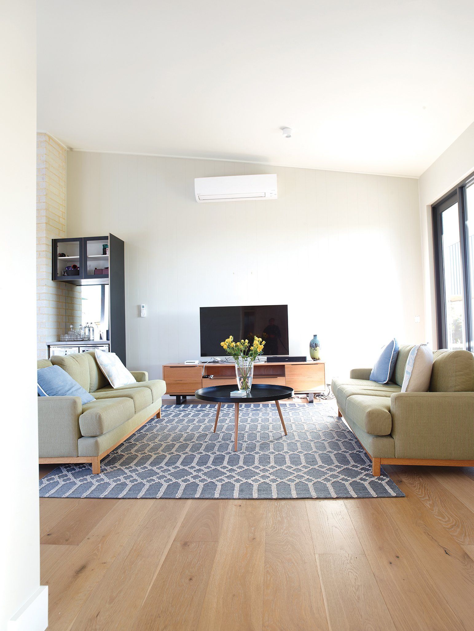 A living room with two couches and a television