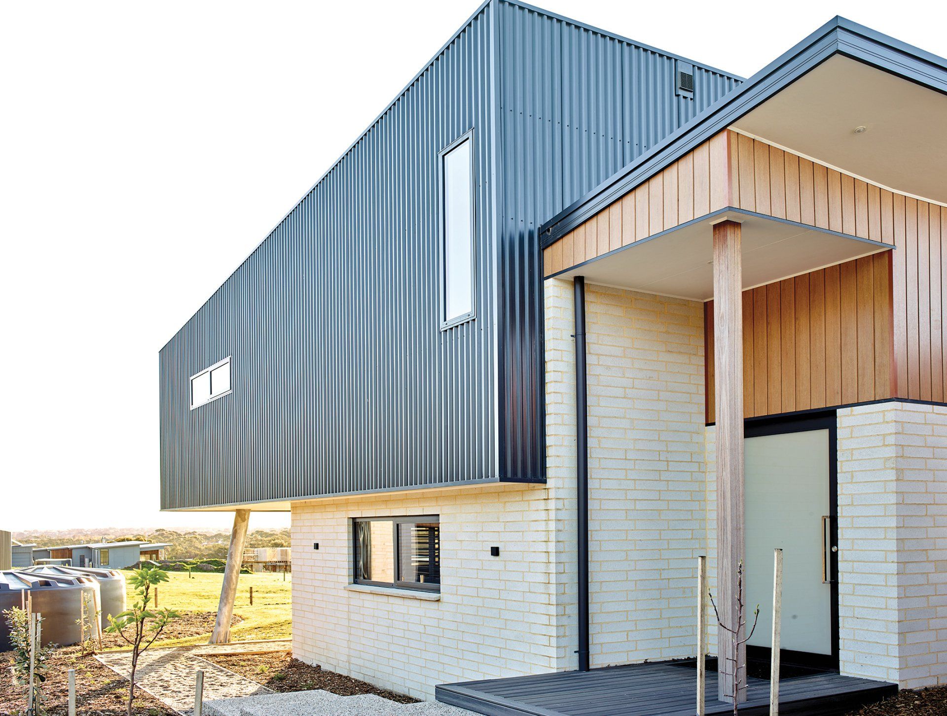 A house with a black siding and a wooden porch