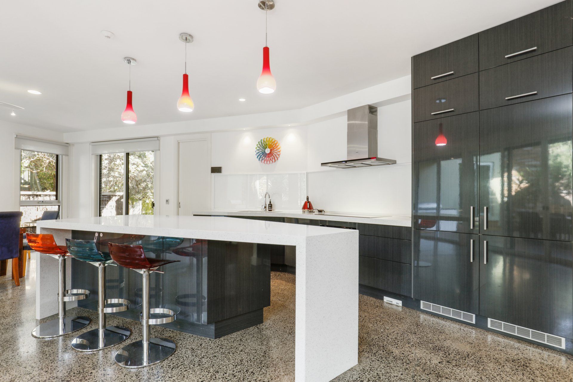 A kitchen with a large island and stools