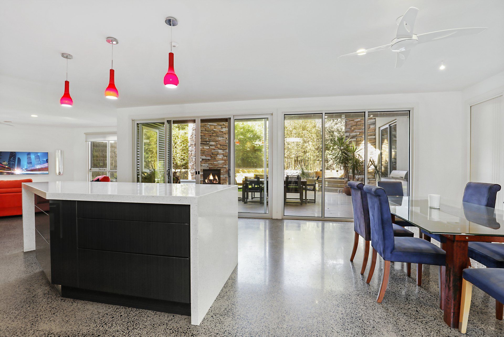 A kitchen with a large island and a dining table and chairs.