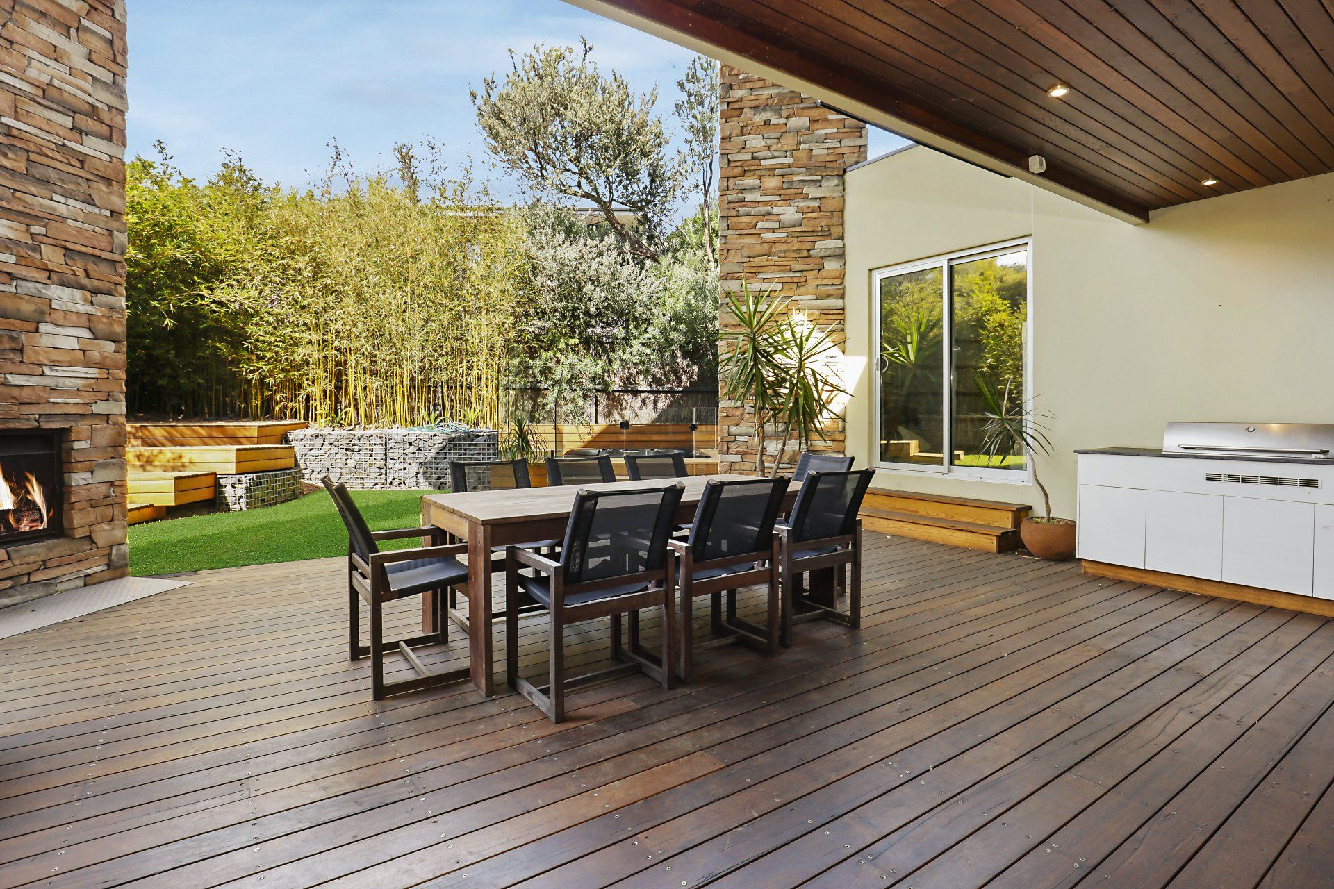 A wooden deck with a table and chairs on it