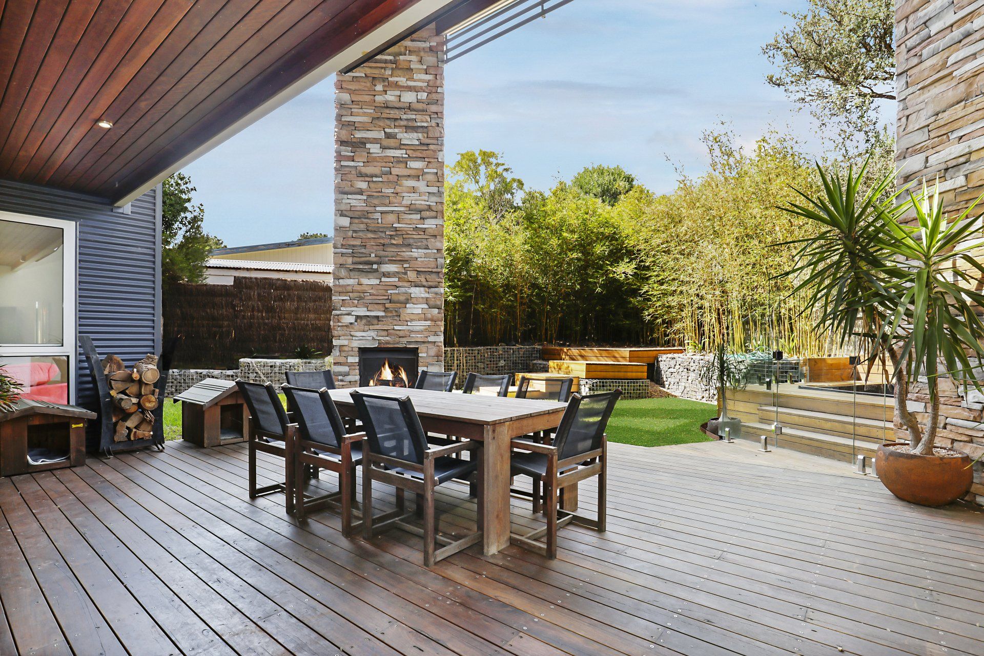 A wooden deck with a table and chairs on it