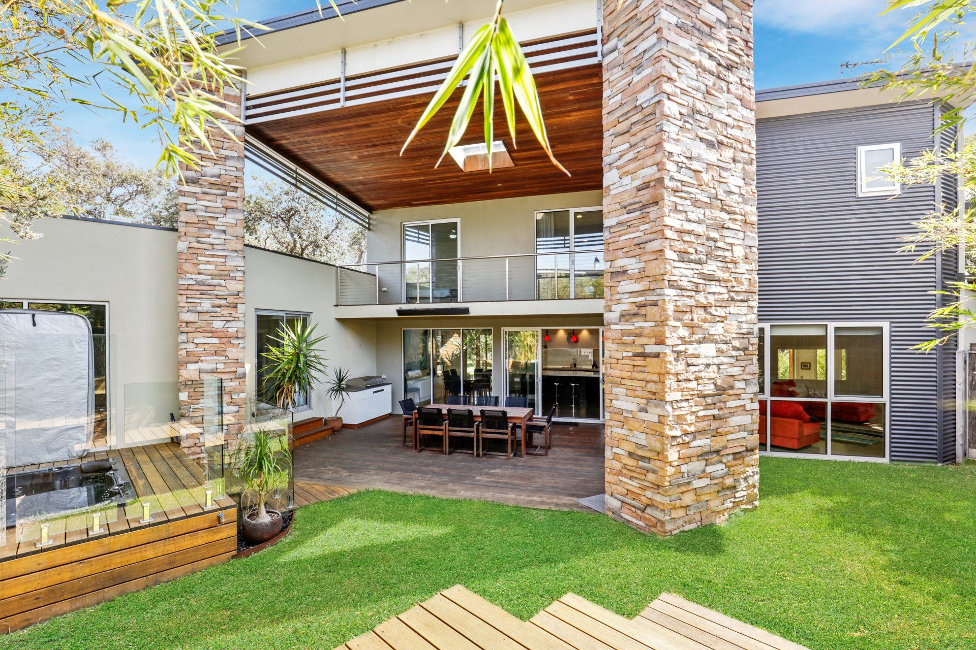 A large house with a patio with a table and chairs
