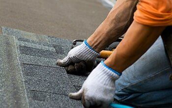 Roofer attaching shingles to the roof - Residential Roofing in Las Vegas Valley, NV Roofer attaching shingles to the roof - Residential Roofing in Las Vegas Valley, NV