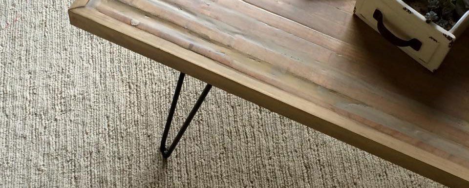 wooden table sitting on light tan carpet