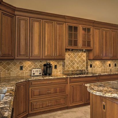 kitchen with brown cabinets and tile backsplash