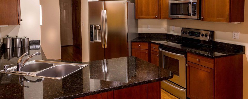dark countertop and cabinets in clean kitch