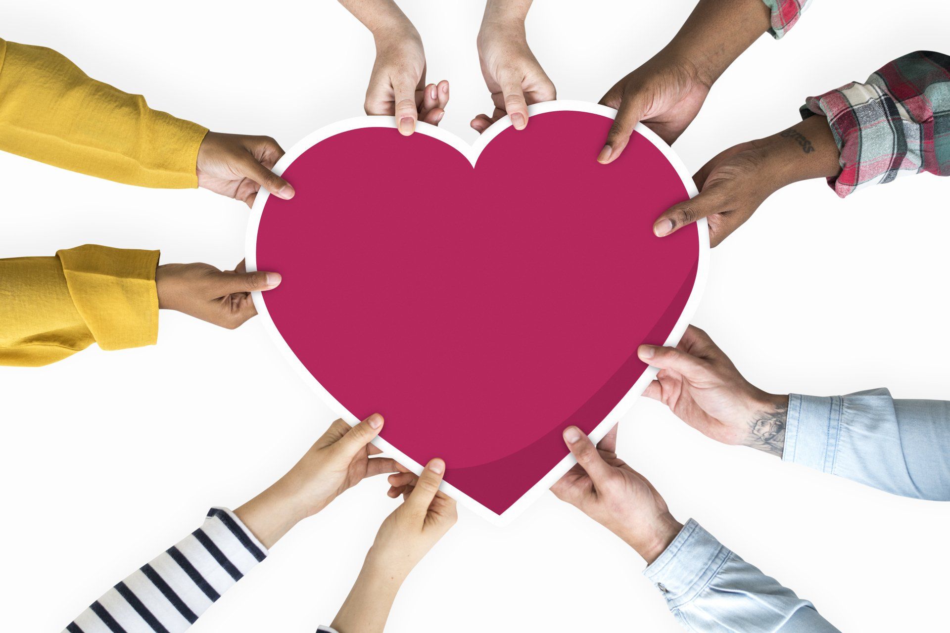 Hands of diverse people holding a pink heart shape together on a white background