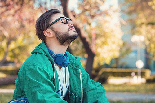 Man Enjoying Fresh Air In Park